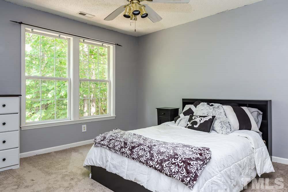9501 Miranda Drive Raleigh, NC 27617 - Photo 24 of 30 Like living in a treehouse with the hardwoods growing outside the window!