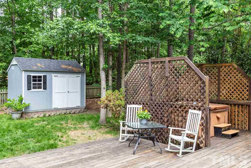 9501 Miranda Drive Raleigh, NC 27617 - Photo 28 of 30 Beyond the darling shed and fence is wooded HOA property separating you from the neighbor!