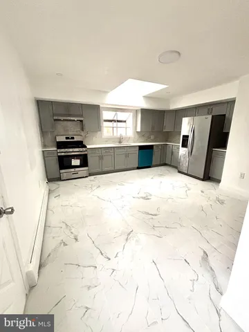 a view of a kitchen with microwave and cabinets