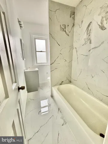 a bathroom with a bathtub and sink