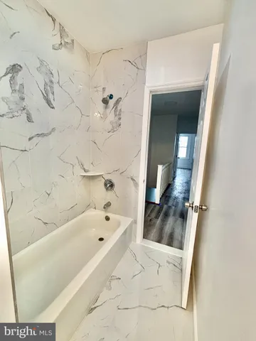 a bathroom with a bathtub and a shower