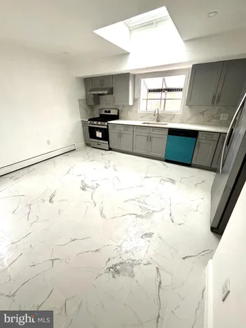 a kitchen with a sink and wooden cabinets