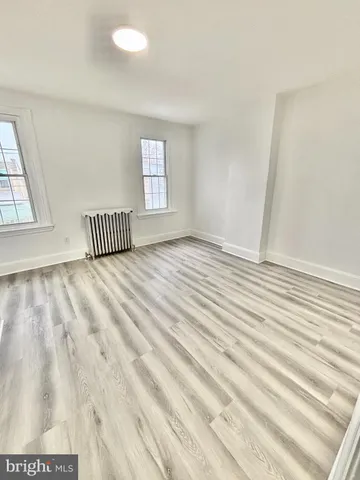 a view of a livingroom with wooden floor and a window