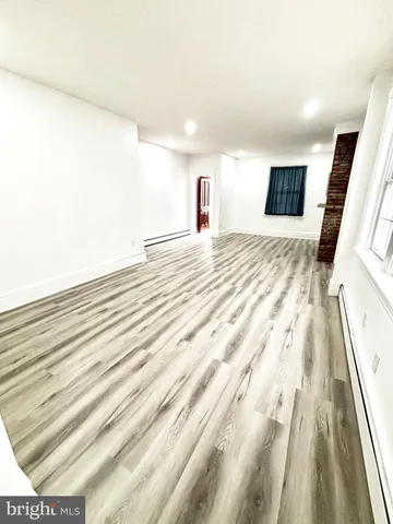 a bedroom with a bed and a flat tv screen on dresser