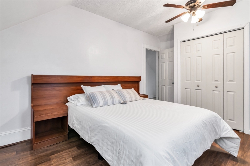 42 D Street Lowell, MA 01851 - Photo 24 of 27 a bedroom with a bed and a ceiling fan