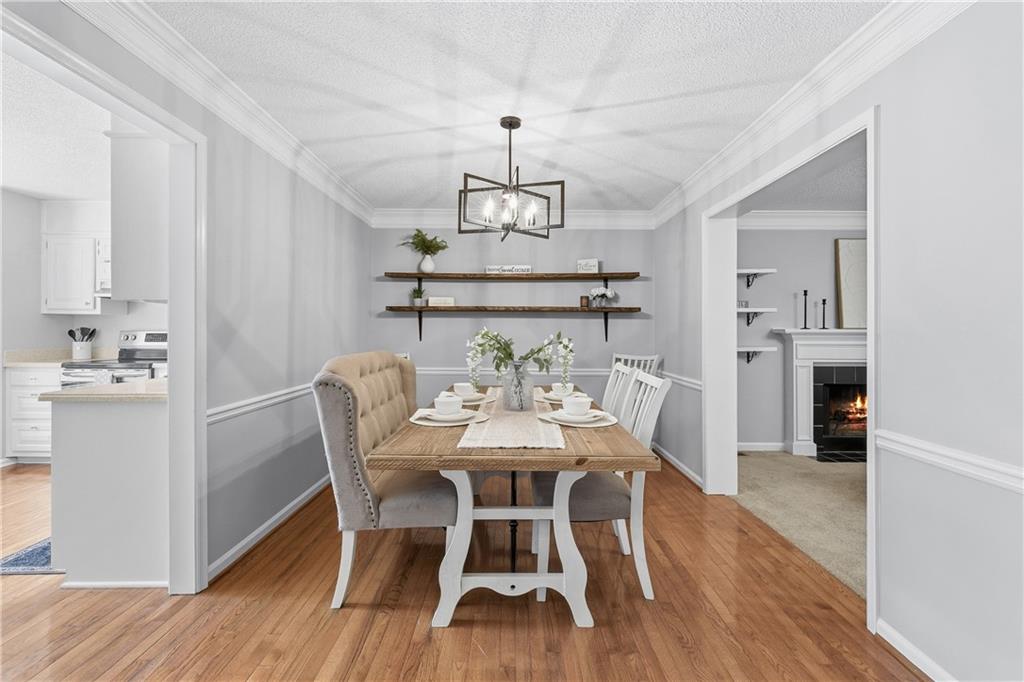 3800 Meeting Street Northwest Duluth, GA 30096 - Photo 11 of 46 a view of a dining room with furniture a chandelier and wooden floor