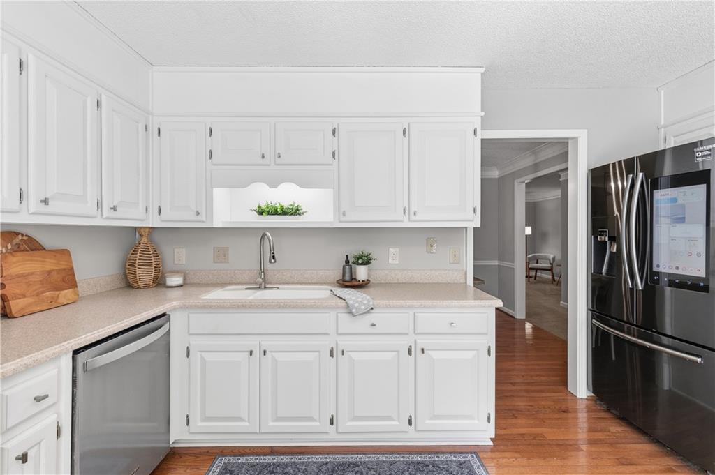 3800 Meeting Street Northwest Duluth, GA 30096 - Photo 15 of 46 a kitchen with stainless steel appliances granite countertop a sink and a refrigerator