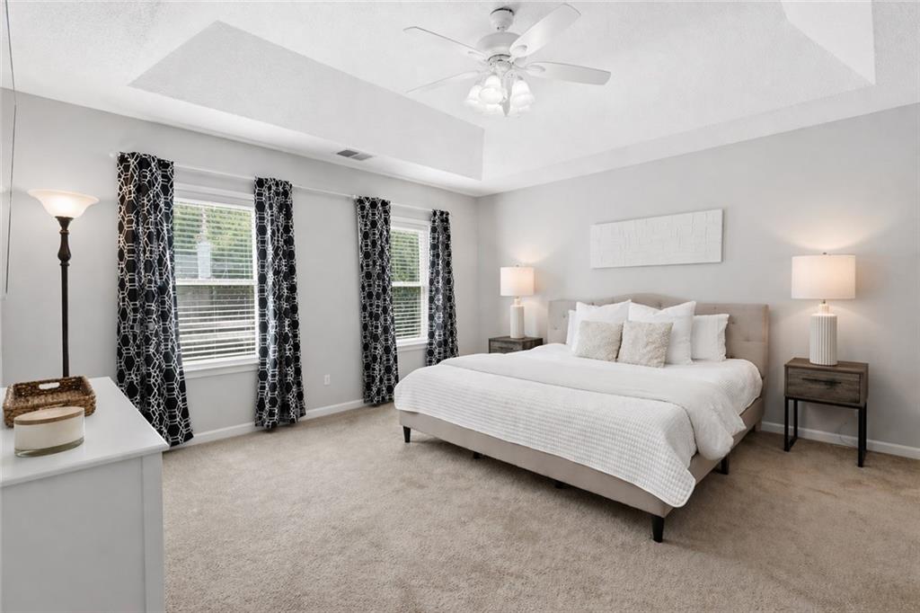 3800 Meeting Street Northwest Duluth, GA 30096 - Photo 21 of 46 a spacious bedroom with a bed and a chandelier