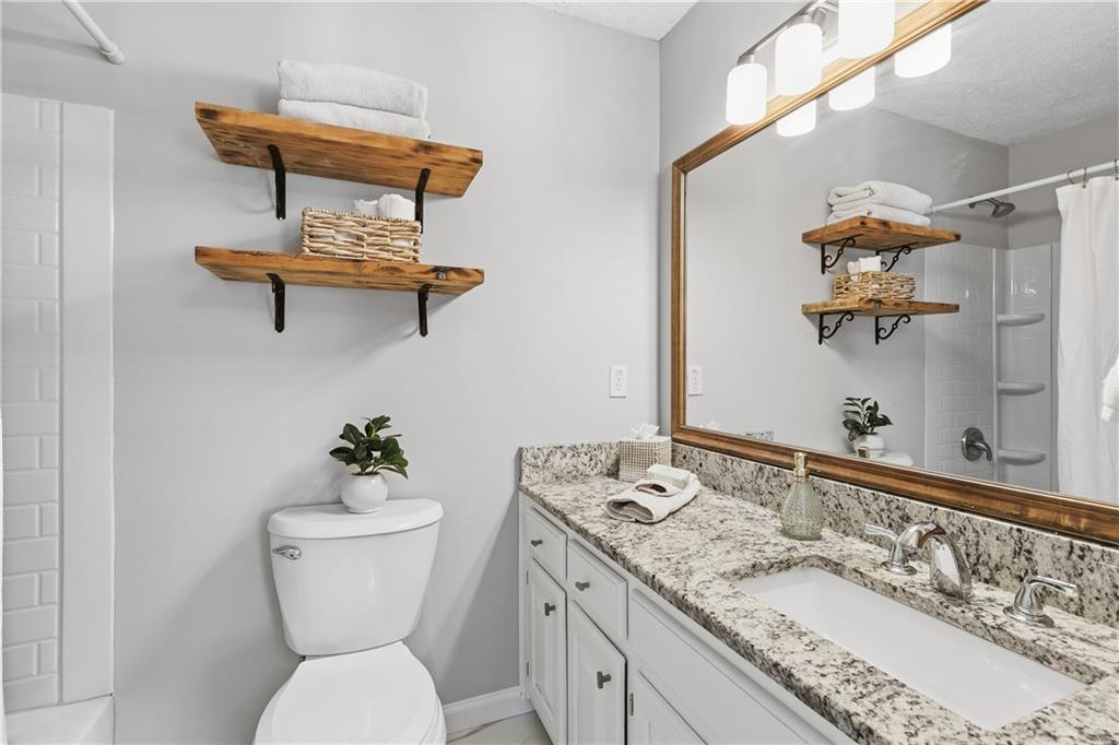 3800 Meeting Street Northwest Duluth, GA 30096 - Photo 23 of 46 a bathroom with a toilet sink and mirror