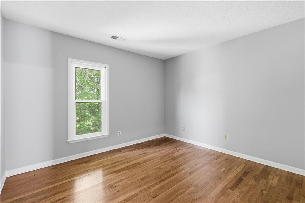 3800 Meeting Street Northwest Duluth, GA 30096 - Photo 26 of 46 an empty room with wooden floor and windows