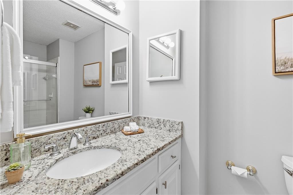 3800 Meeting Street Northwest Duluth, GA 30096 - Photo 28 of 46 a bathroom with a granite countertop sink and a mirror