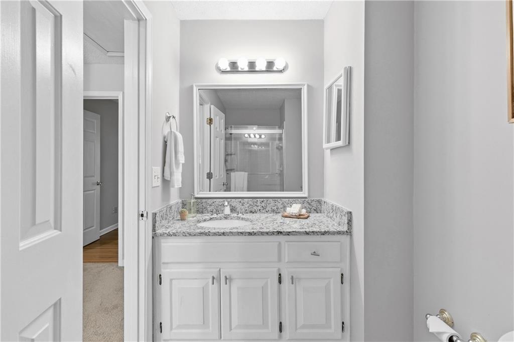 3800 Meeting Street Northwest Duluth, GA 30096 - Photo 29 of 46 a bathroom with a granite countertop sink a mirror and a vanity