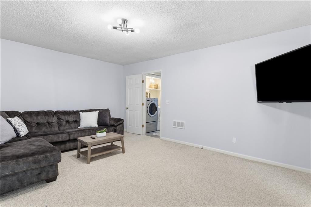 3800 Meeting Street Northwest Duluth, GA 30096 - Photo 35 of 46 a living room with furniture and a flat screen tv