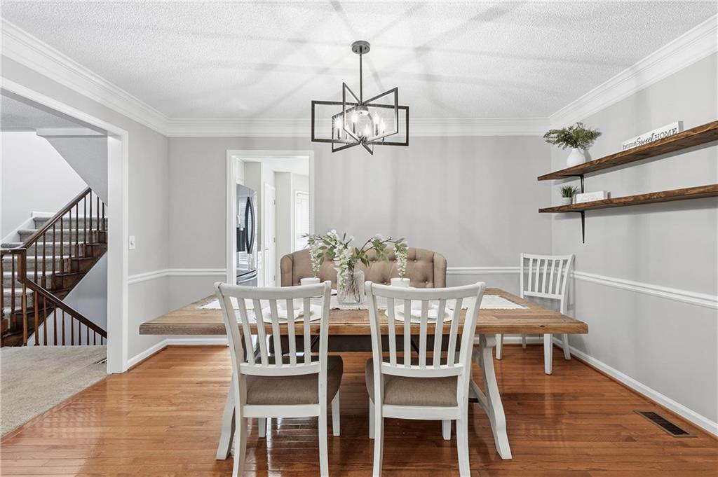 3800 Meeting Street Northwest Duluth, GA 30096 - Photo 10 of 46 a view of a dining room with furniture wooden floor and chandelier