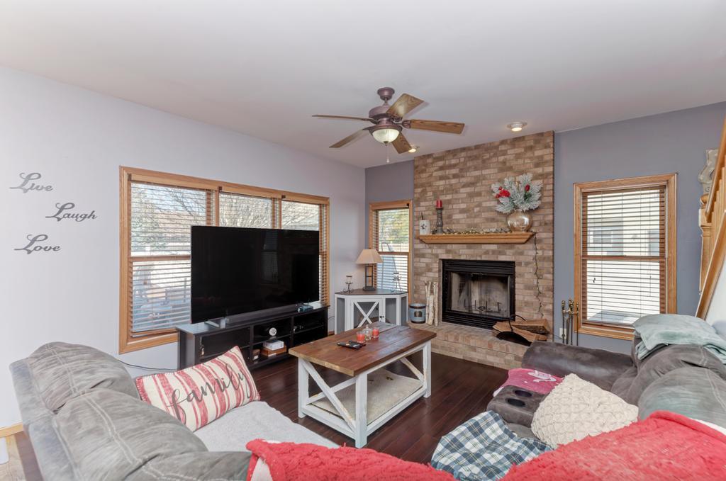 1648 Periwinkle Drive Morris, IL 60450 - Photo 16 of 40 a living room with furniture a flat screen tv and a fireplace