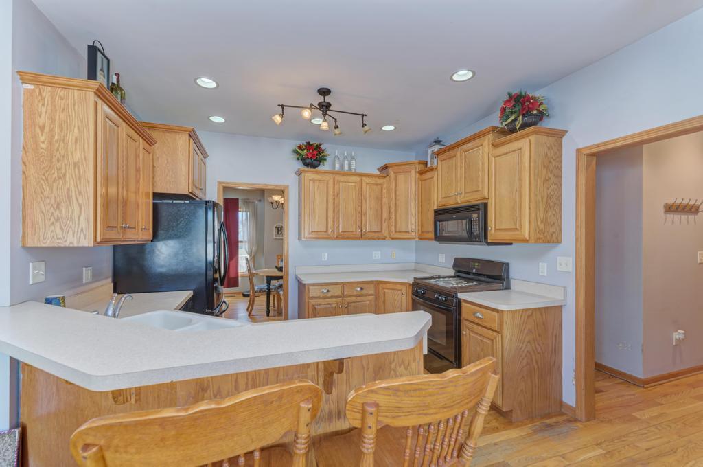 1648 Periwinkle Drive Morris, IL 60450 - Photo 10 of 40 a kitchen with kitchen island granite countertop a sink a counter top space appliances and cabinets