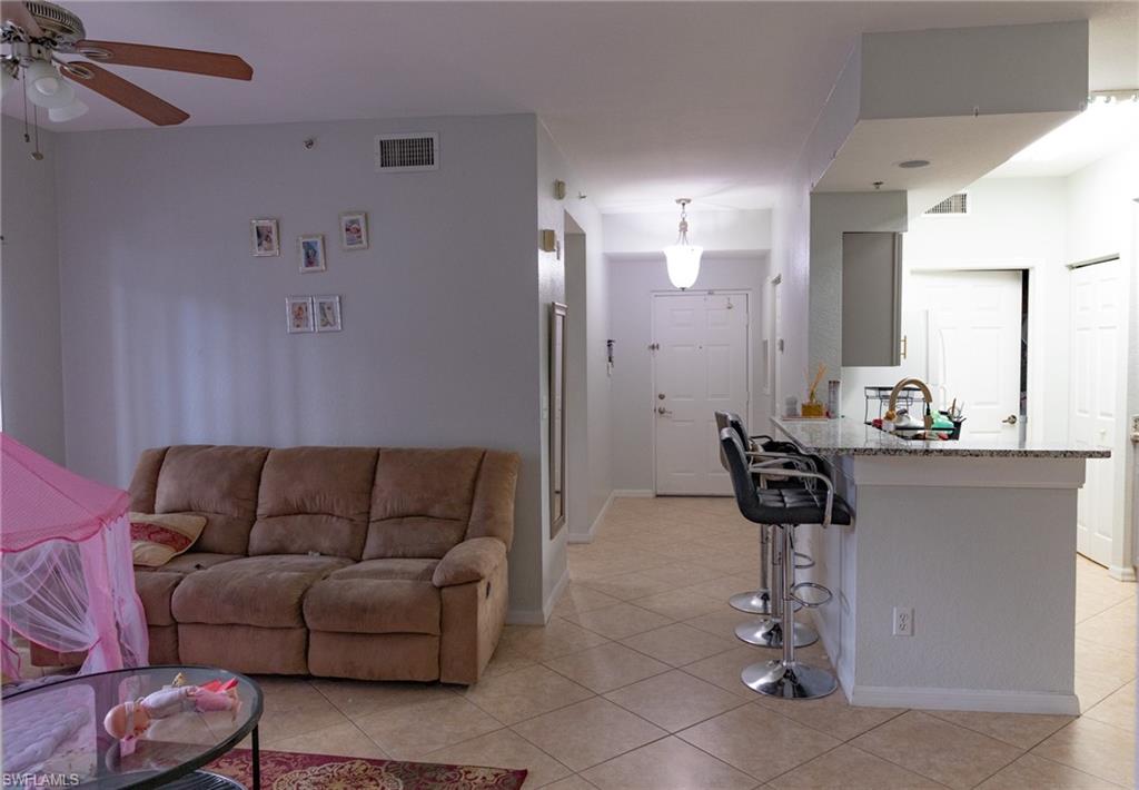 4650 St Croix Lane, Unit 726 Naples, FL 34109 - Photo 11 of 15 Living area with a ceiling fan and light tile patterned floors