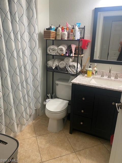 4650 St Croix Lane, Unit 726 Naples, FL 34109 - Photo 12 of 14 a bathroom with a toilet sink and mirror