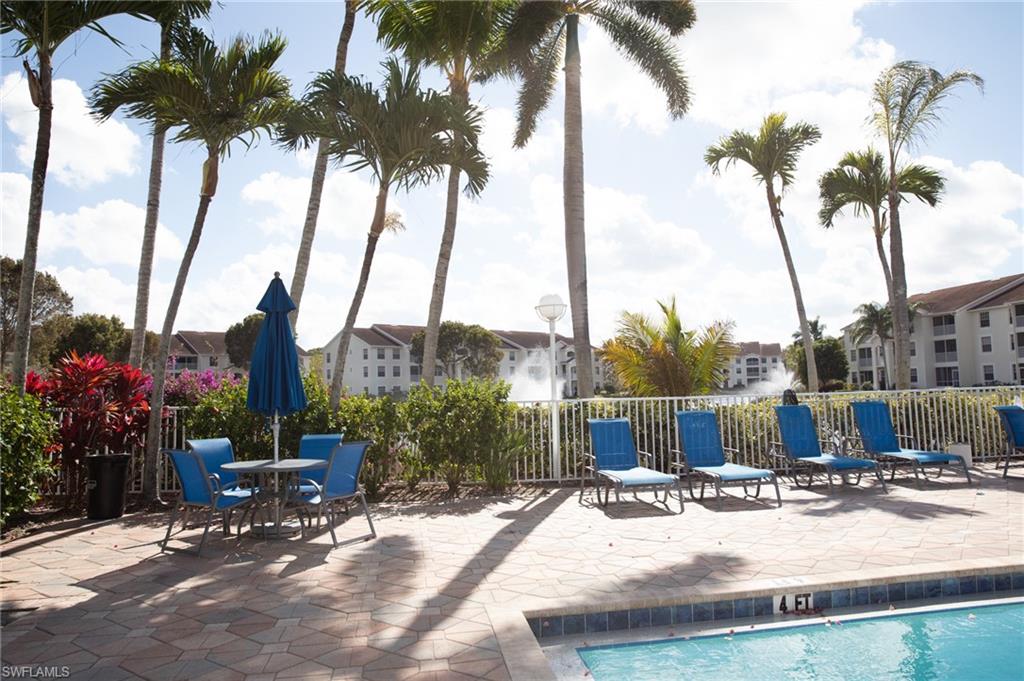 4650 St Croix Lane, Unit 726 Naples, FL 34109 - Photo 3 of 15 Community pool with a patio and outdoor dining area