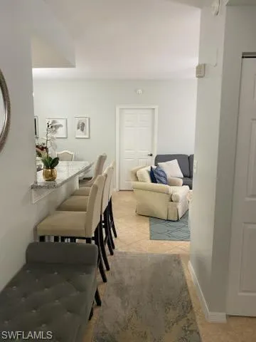 a living room with furniture and a mirror