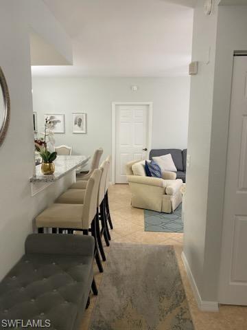 4650 St Croix Lane, Unit 726 Naples, FL 34109 - Photo 5 of 14 a living room with furniture and a mirror