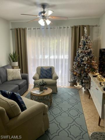 4650 St Croix Lane, Unit 726 Naples, FL 34109 - Photo 8 of 14 a living room with furniture and a large window