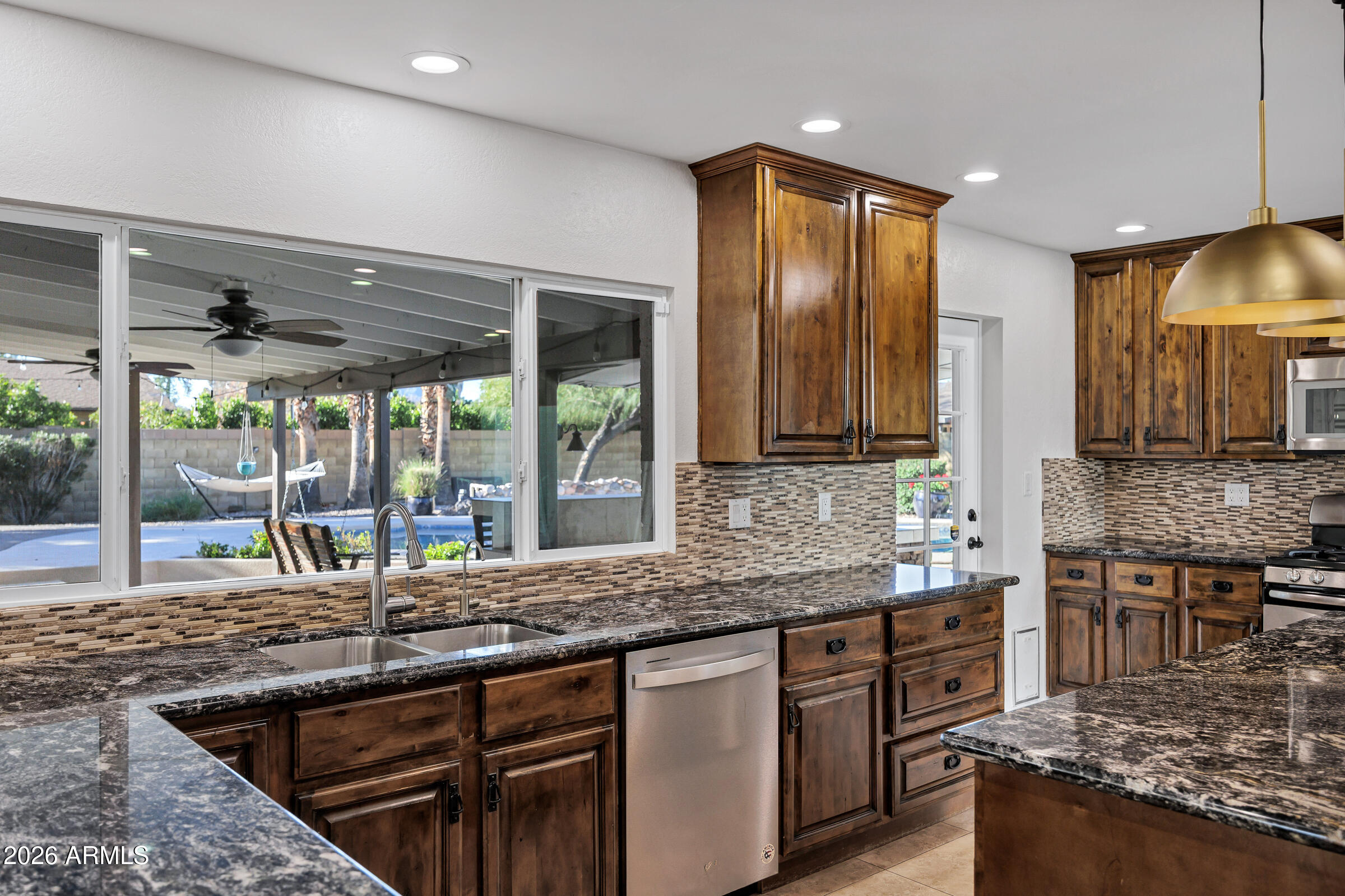 11202 North 42nd Place Phoenix, AZ 85028 - Photo 14 of 55 a kitchen with stainless steel appliances granite countertop a sink and a counter space