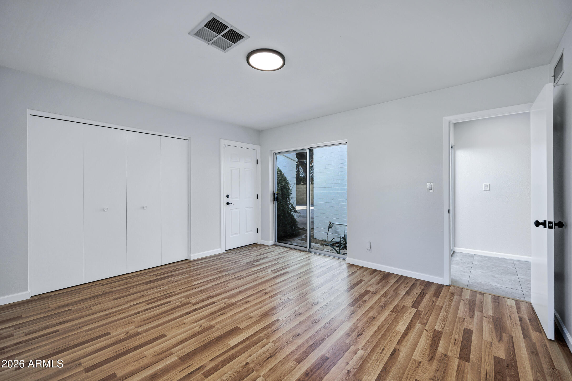 11202 North 42nd Place Phoenix, AZ 85028 - Photo 22 of 55 a view of an empty room with wooden floor