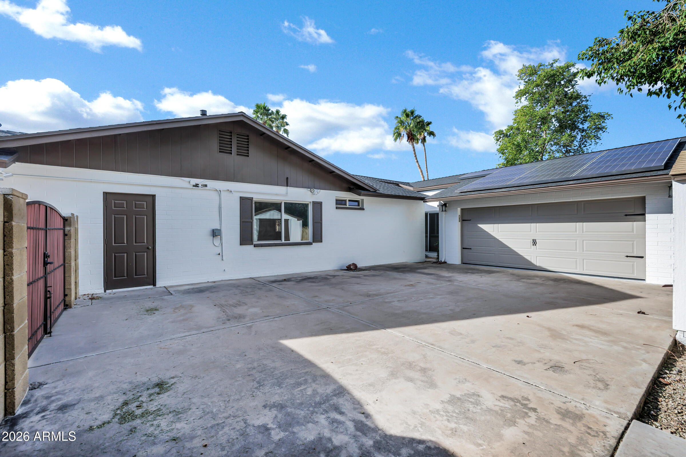 11202 North 42nd Place Phoenix, AZ 85028 - Photo 38 of 55 a view of a white house with a garage and yard