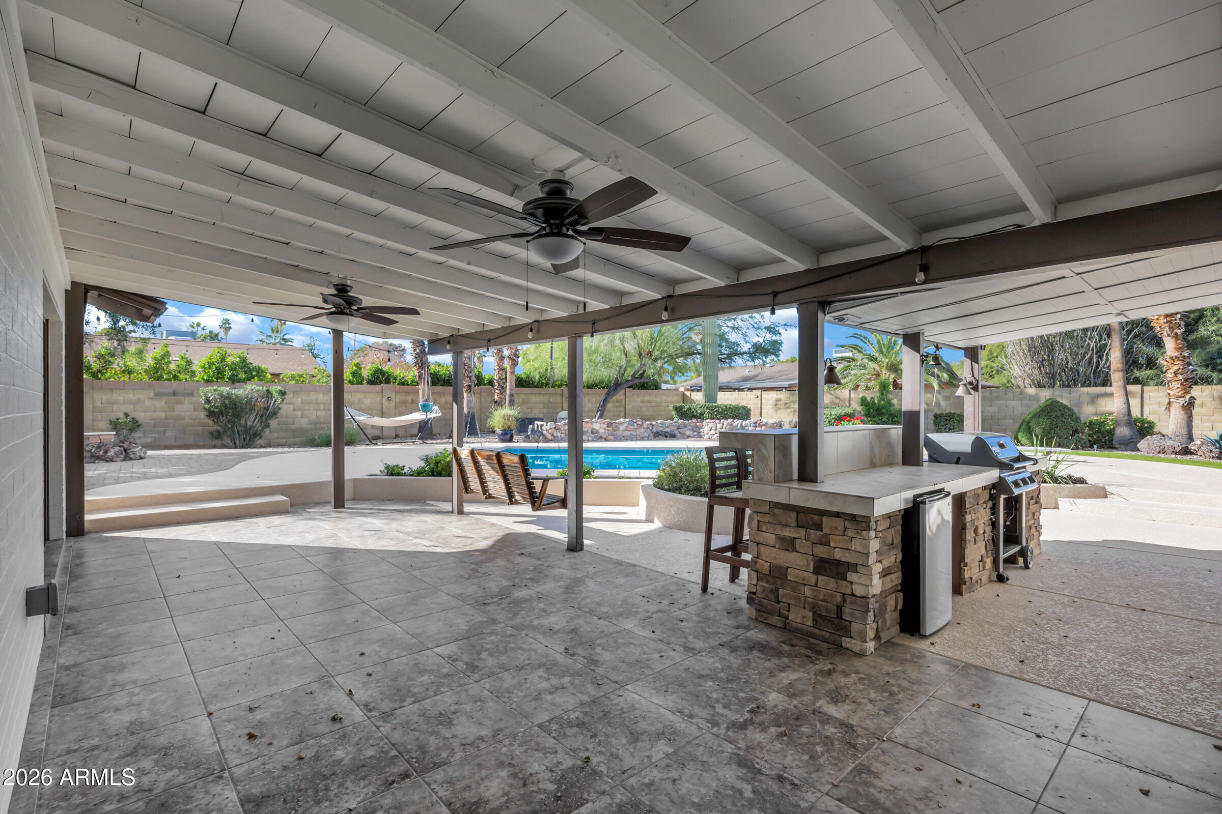 11202 North 42nd Place Phoenix, AZ 85028 - Photo 47 of 55 a view of a porch with table and chairs under an umbrella