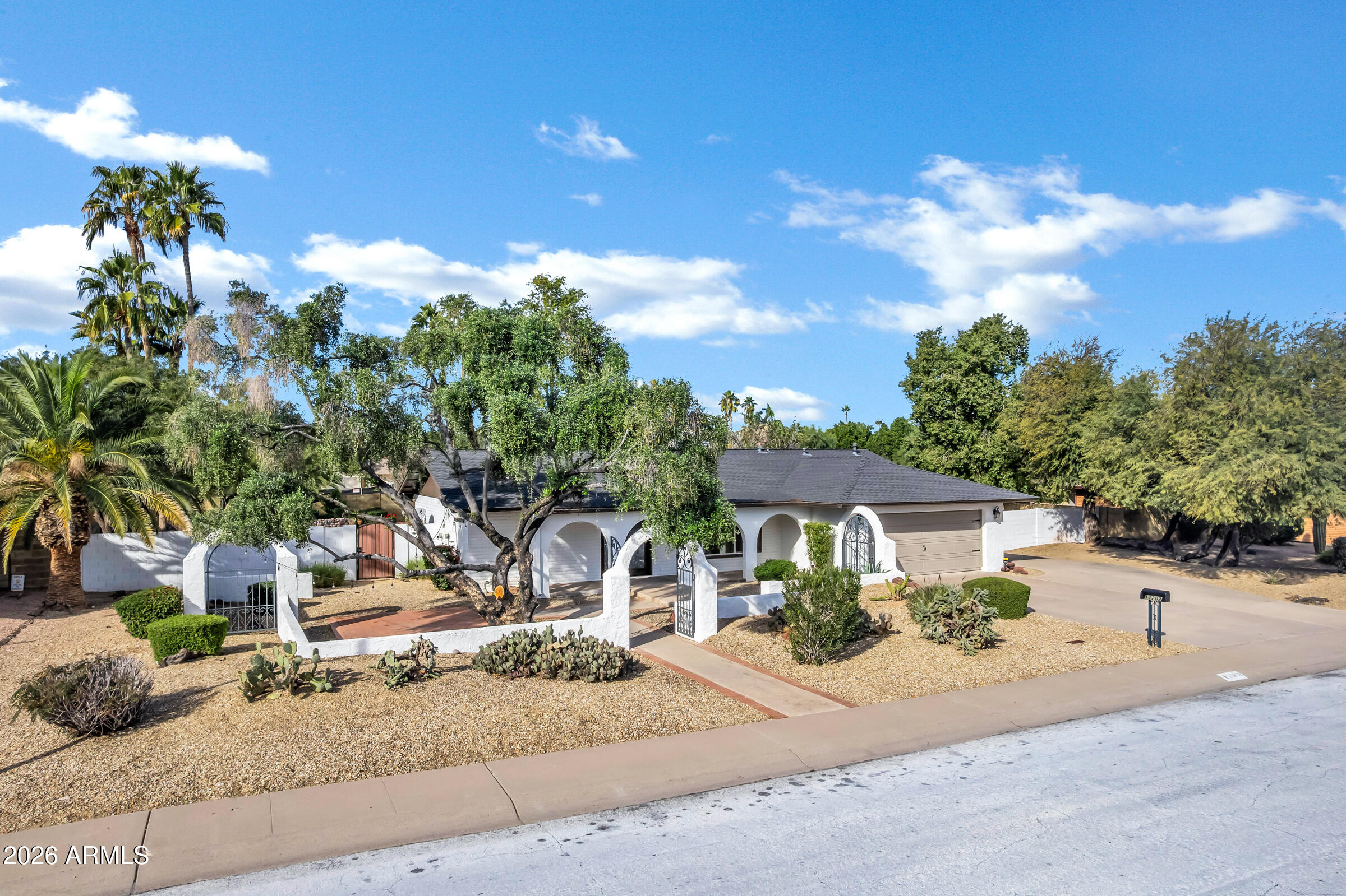 11202 North 42nd Place Phoenix, AZ 85028 - Photo 49 of 55 a front view of a house with a yard and garage