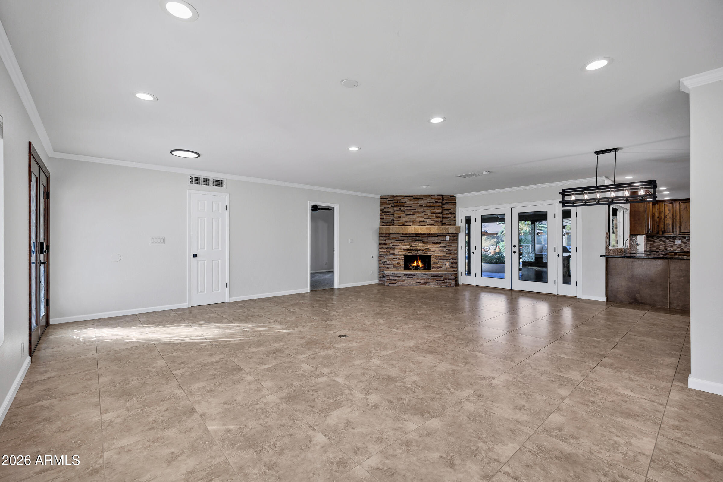 11202 North 42nd Place Phoenix, AZ 85028 - Photo 9 of 55 an empty room with furniture and way to kitchen