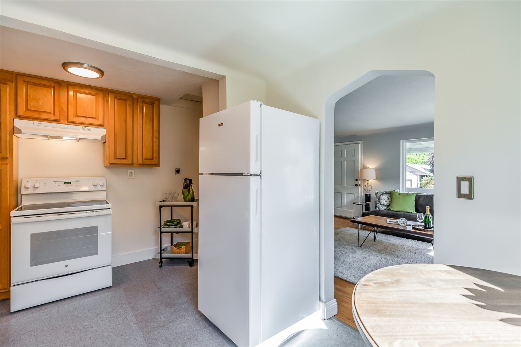 3525 Southwest Webster Street Seattle, WA 98126 - Photo 12 of 37 a kitchen with a refrigerator and a stove top oven