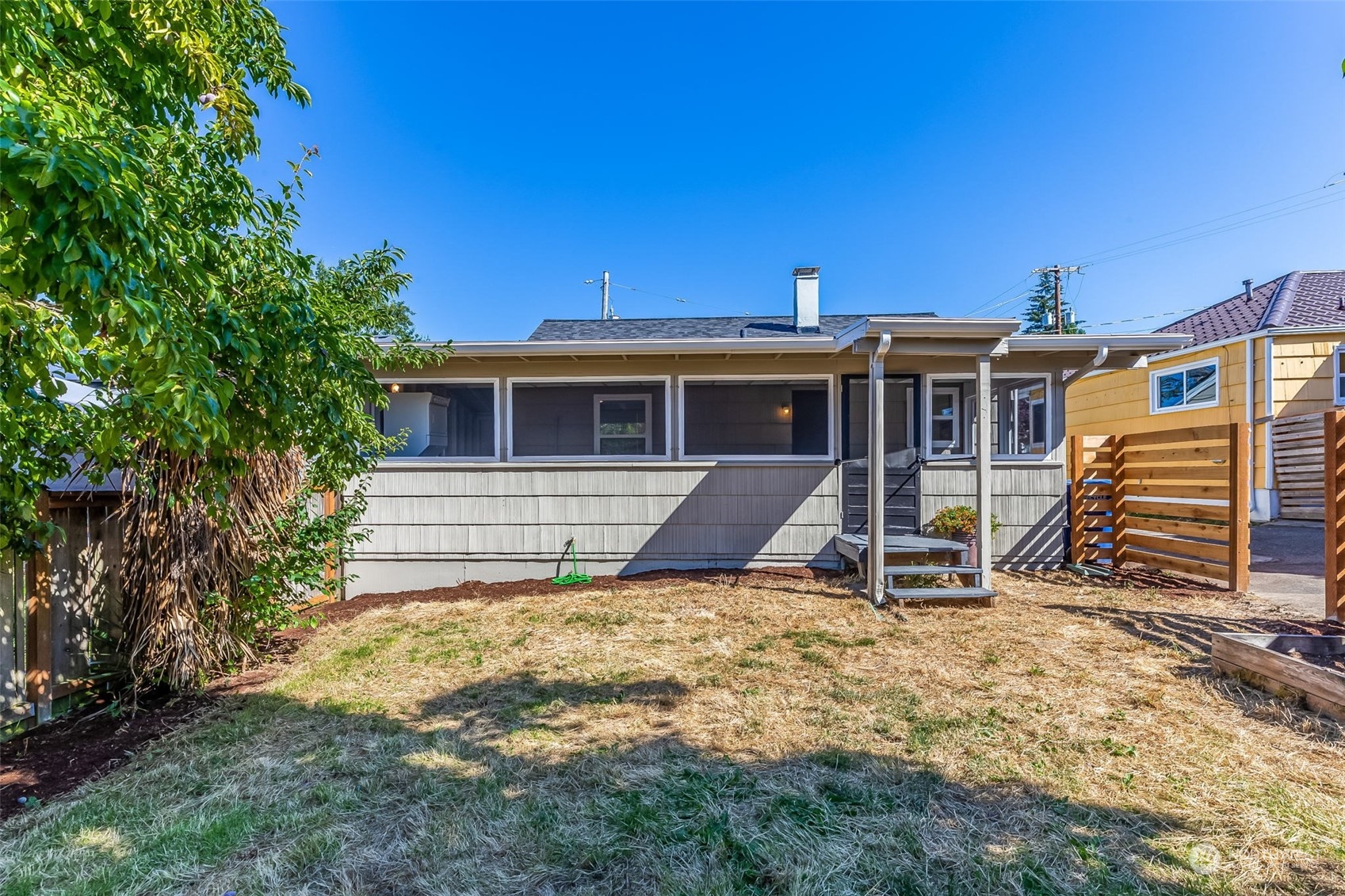 3525 Southwest Webster Street Seattle, WA 98126 - Photo 34 of 37 a view of a house with a yard and sitting area