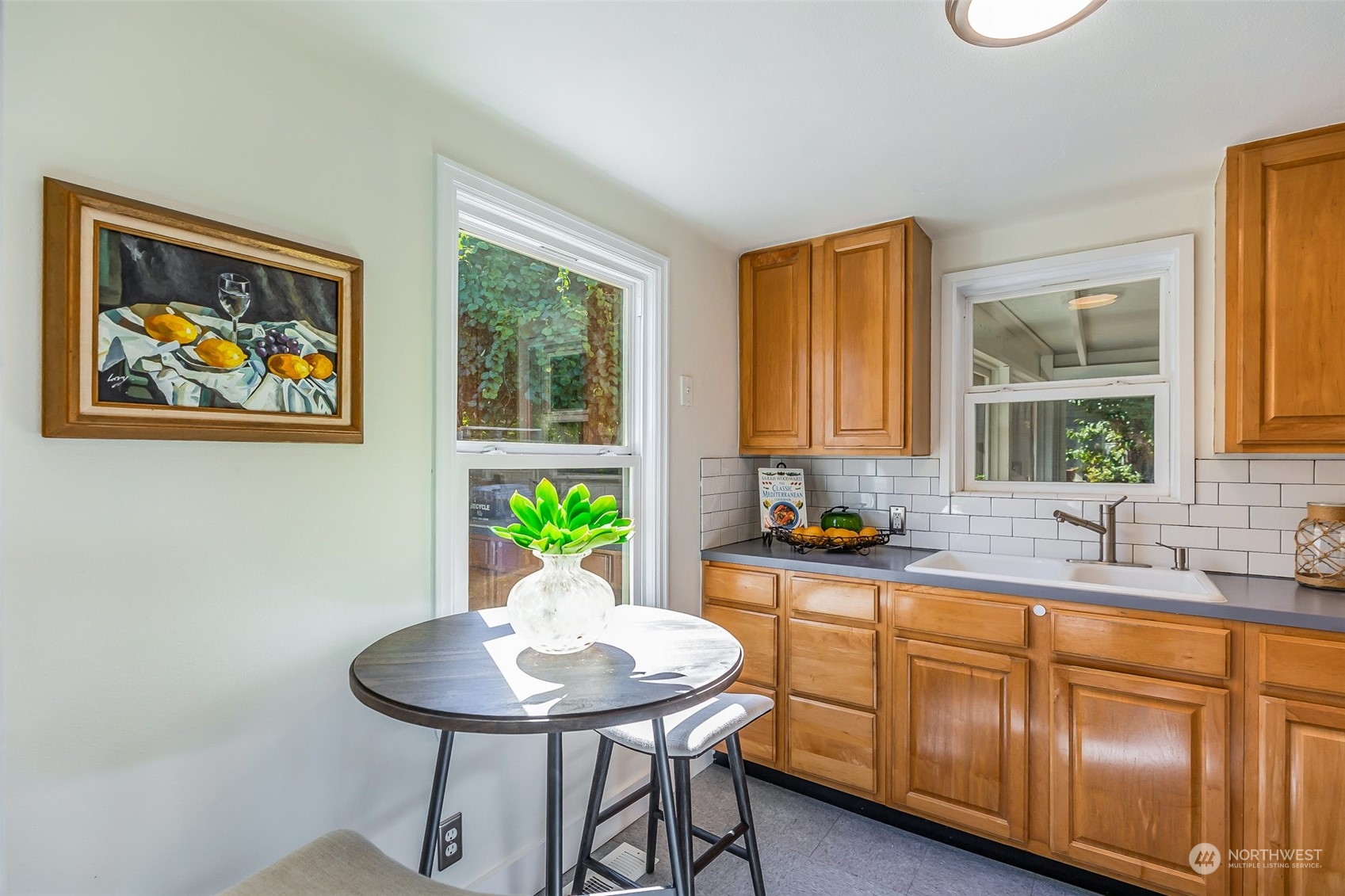 3525 Southwest Webster Street Seattle, WA 98126 - Photo 10 of 37 a kitchen with stainless steel appliances granite countertop a sink a window a dining table and chairs