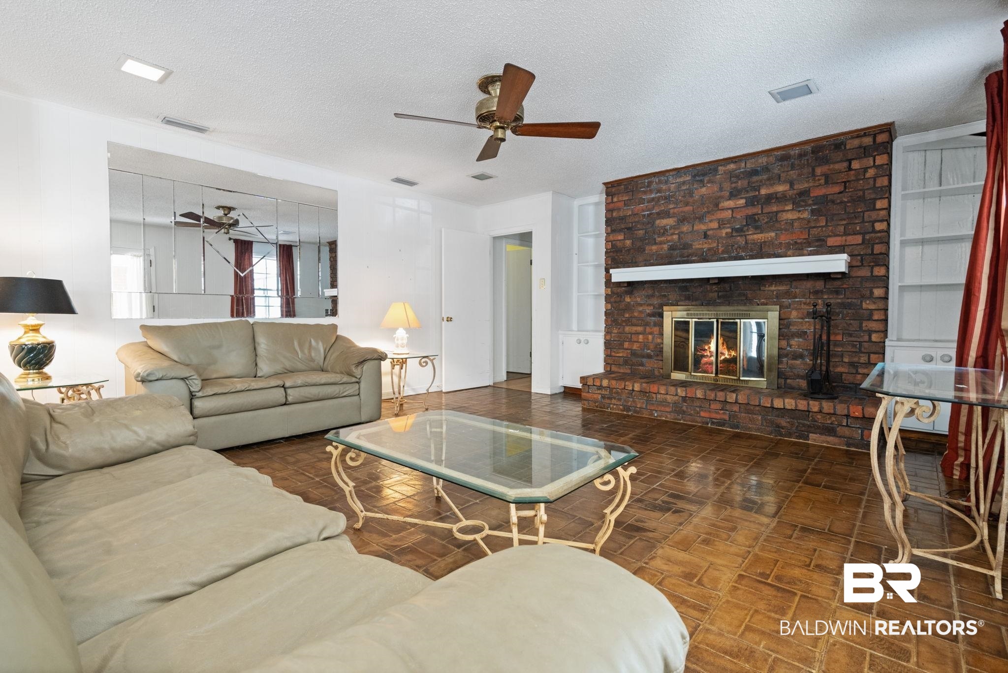 6261 Old Pascagoula Road Theodore, AL 36582 - Photo 14 of 29 Living room with ceiling fan, a fireplace, and a textured ceiling
