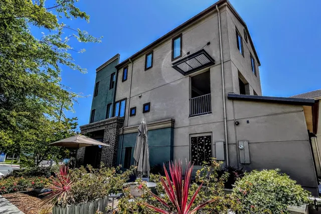 a view of a house with a flower garden