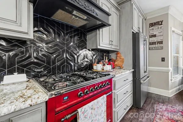 a kitchen with stainless steel appliances granite countertop a stove and a sink