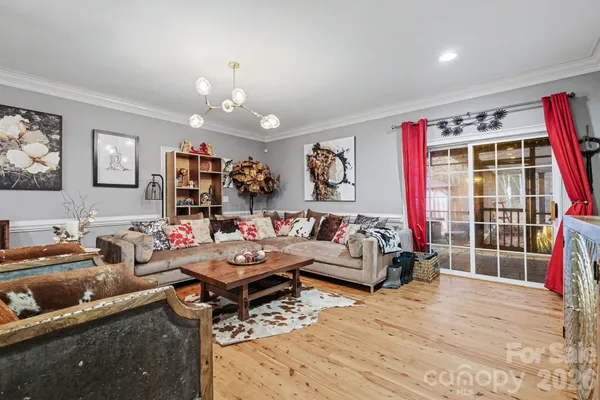 a living room with furniture a rug and a window