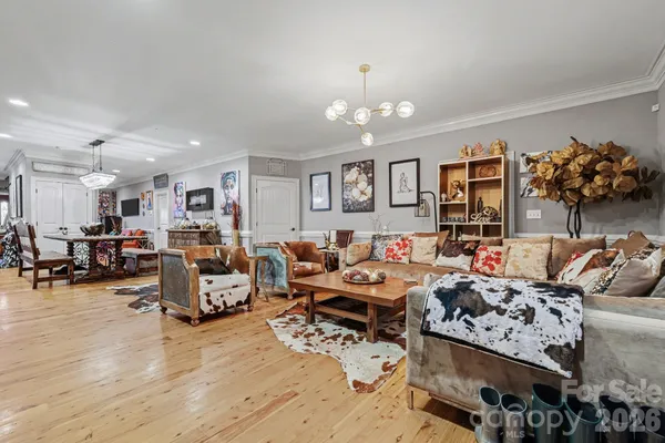 a living room with lots of furniture and a chandelier