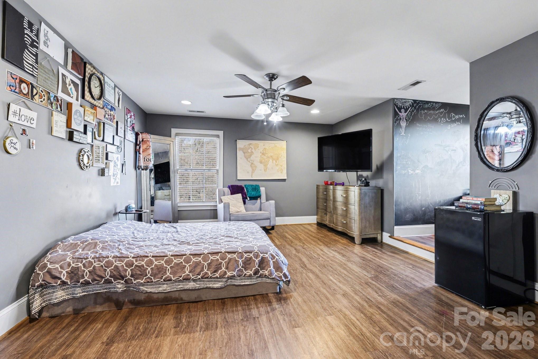 105 Eubanks Road Monroe, NC 28112 - Photo 18 of 41 a bedroom with a bed and a flat tv screen on dresser