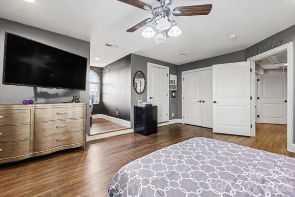 a bedroom with a bed and a flat screen tv