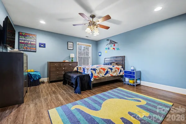 a bedroom with furniture and a wooden floor