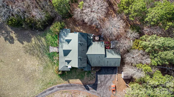 a view of a dry yard with wooden fence