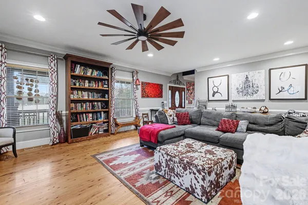 a living room with furniture and a book shelf