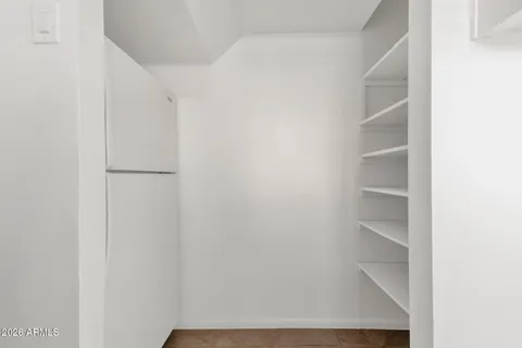 a kitchen with white cabinets and white appliances