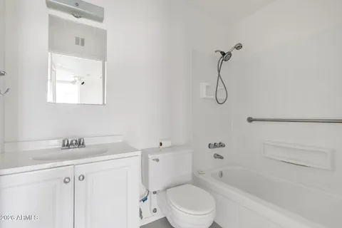 a view of a big room with wooden floor and windows
