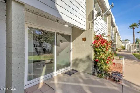a view of a house with backyard and a tree