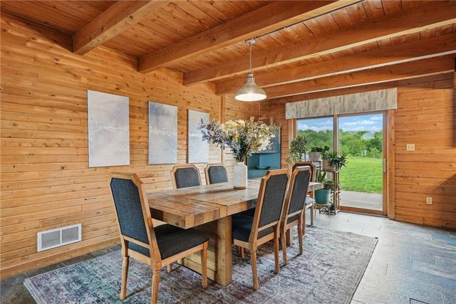 a dining room with furniture and wooden floor
