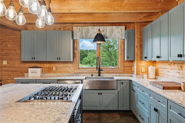 a kitchen that has a sink and a stove